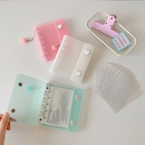 Detail view of mini glitter photo albums with heart buckles and matching charms