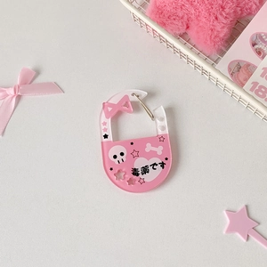 Close-up of pink acrylic carabiner with skull and heart graffiti for backpack decor
