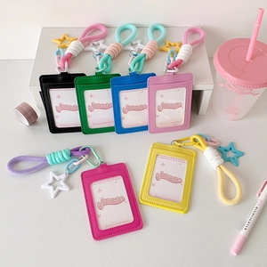Colorful leather card holder sets with star charms and braided lanyards on a desk