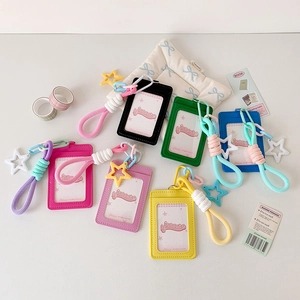 Detail of colorful faux leather card holders with woven lanyards and star charms