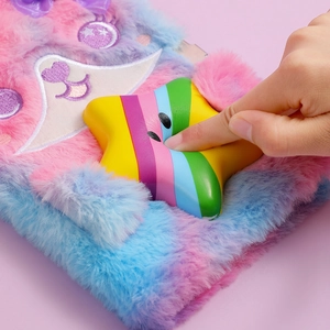 Detail of pink and blue plush A5 notebook featuring a squishy rainbow star for stress relief