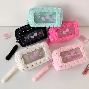 Detail view of colorful plush cosmetic bags with transparent PVC windows and heart prints