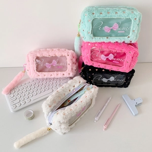 Close-up of plush pencil case with gold heart patterns and transparent window
