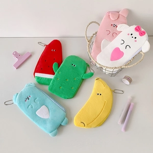 Plush fruit and cactus pencil cases set with zipper and metal chains on a white desk