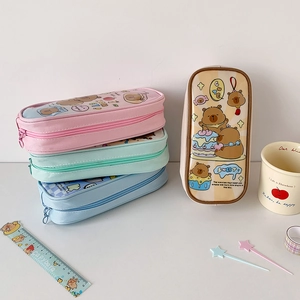 Close-up of colorful canvas pencil cases showing large storage capacity and cute prints