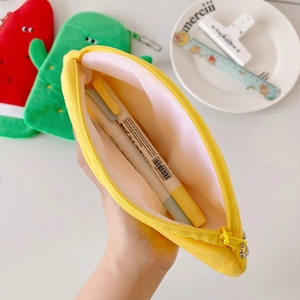 Internal view of plush banana pencil case with pink lining showing storage capacity