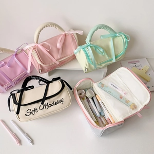 Detail of soft makeup bag showing the inner mesh pocket and ribbon bow decoration