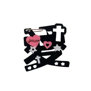 Y2K style black acrylic character pin with pink hearts and star charms for backpacks