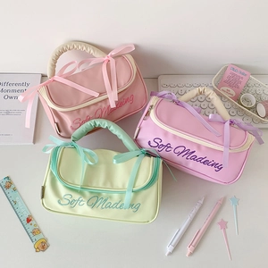 Pastel ballet-style large cosmetic bags with ruffled handles and ribbon bows