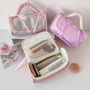 Three-piece large PU makeup storage bag set with soft handle and ribbon bow detail