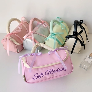 Five assorted colors of portable PU cosmetic bags with bows and soft padded handles