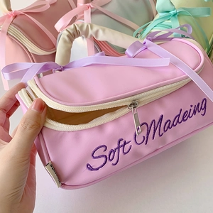 Close-up of pastel cosmetics bag showing PU leather texture and ribbon bow detail