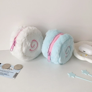 Close-up of cute plush narutomaki coin purses in white and blue with pink zippers