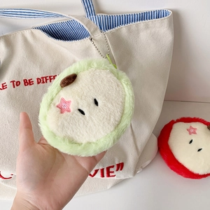 Detail of plush apple coin purses in green and red with star embroidery and metal chain
