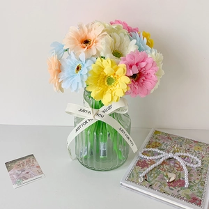Colorful artificial daisy pens in green striped glass vase with Just For You ribbon