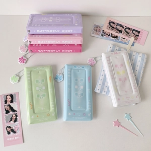 Detail of colorful butterfly knot photo albums with flower pendants in various pastel colors