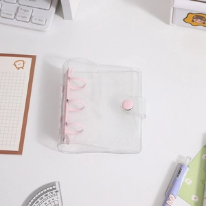 Close-up of mini glitter PVC binder cover with pink 3-ring clip and snap button