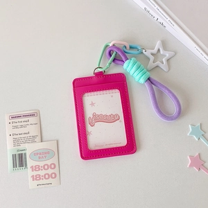 Detail of rose pink PU leather card holder with colorful star pendant and braided strap