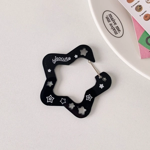 Star-shaped black acrylic keychain clip with white star pattern and metal buckle