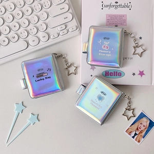 Detailed macro view of a laser holographic mini photo album with a star metal keychain