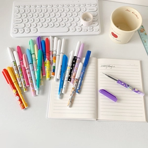 Close-up of cartoon gel pen set with colorful patterns on a minimalist white desk setup