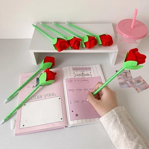 Creative red rose ballpoint pens with green stems in a cozy stationery gift set