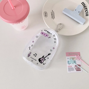 Detail of transparent PVC doll bag with musical print and metal carabiner hook