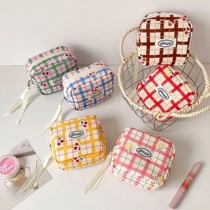 Detail of cute cherry print checkered makeup bags with silk ribbon zipper pullers