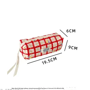 Detail view of red plaid pencil case with cherry print and specific size dimensions