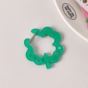 Translucent green clover acrylic keychain with hollow star prints and silver clasp