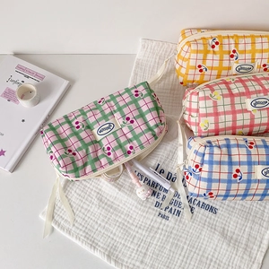 Detailed view of plaid canvas pencil bags with secure zippers and side carry handles