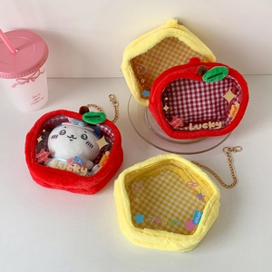 Macro shot of apple-shaped plush display bags with clear windows and metal chains