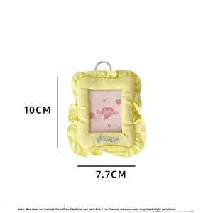 Detail view of yellow fabric card holder with lace edges and dimension specifications