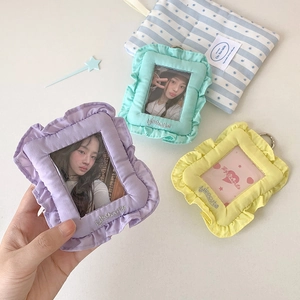 Detailed view of plush lace card holders in purple, green, and yellow with metal rings