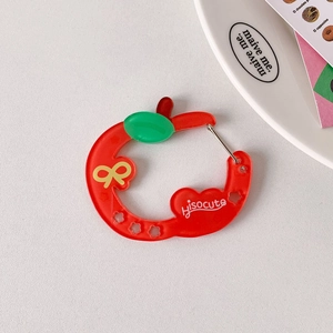 Translucent red acrylic apple keychain with yellow bow and metal clasp attachment