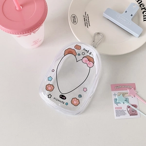 Macro detail of transparent PVC mini pouch featuring cute bear prints and metal hook