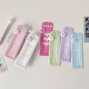 Flat lay of colorful Korean style card holders with bow motifs and matching charms