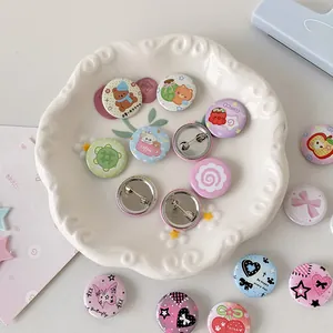 Macro view of 25mm mini cartoon tinplate badges with cute bear and heart patterns