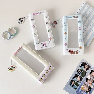 Detailed close-up of three colorful cartoon dog photo albums with transparent card windows
