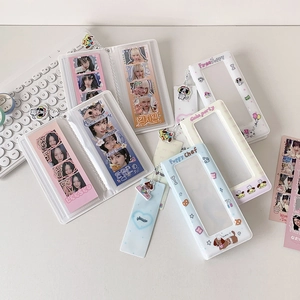Detail of cartoon photocard album and card holder with puppy pendant on a desk