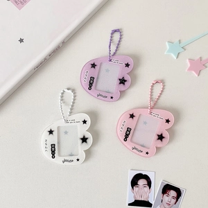 Macro shot of wing-shaped acrylic photo frame keychains in purple, pink, and white