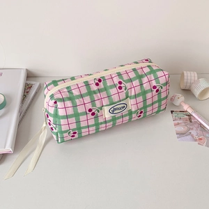 Detailed view of pink plaid pencil case with cherry patterns and soft canvas texture