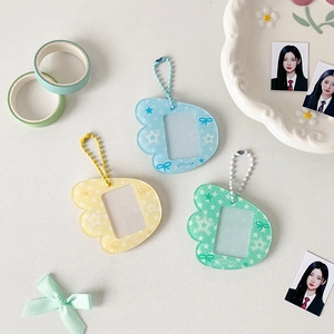 Macro view of acrylic wing-shaped photo card holders in pastel colors with bead chains