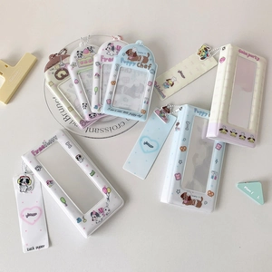 Macro view of cute cartoon puppy card holders and mini photo albums with metal chains