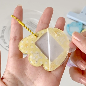 Light yellow star glitter acrylic card holder with wing detail and ball chain keychain