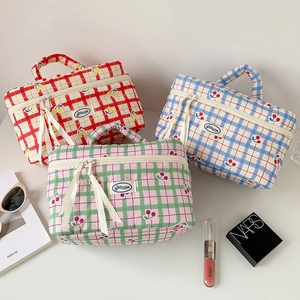 Beauty case trapuntati a quadretti con ciliegie in rosso, blu e verde e manico per trasporto