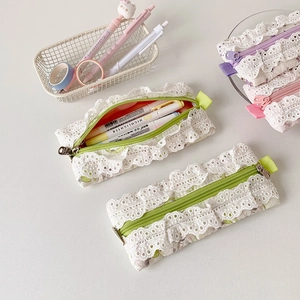Detail view of cotton floral pencil case with delicate lace edges and zip closure