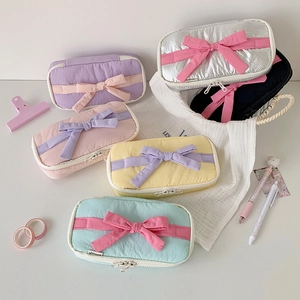 Pastel bow pencil cases in various colors like lavender and mint with zipper closure