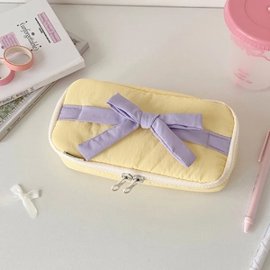 Detail of yellow bow pencil case with purple ribbon and double metal zippers
