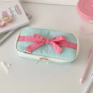 Top-view of mint green and pink bow pencil case with double zipper and cute stationery